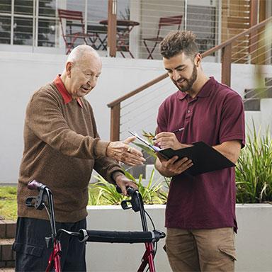 Younger man setting up services for elderly man